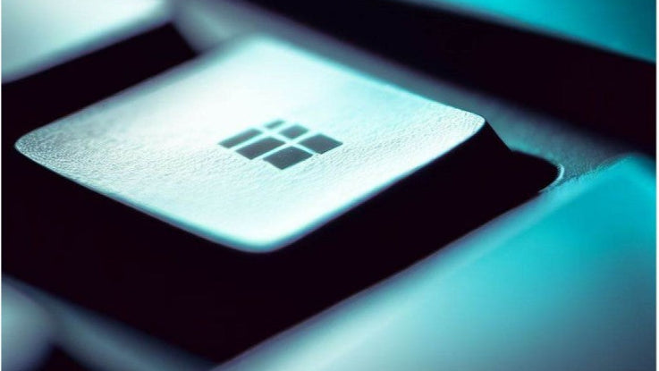 Close-up of a computer keyboard with a focus on a key, likely indicating a brand logo.